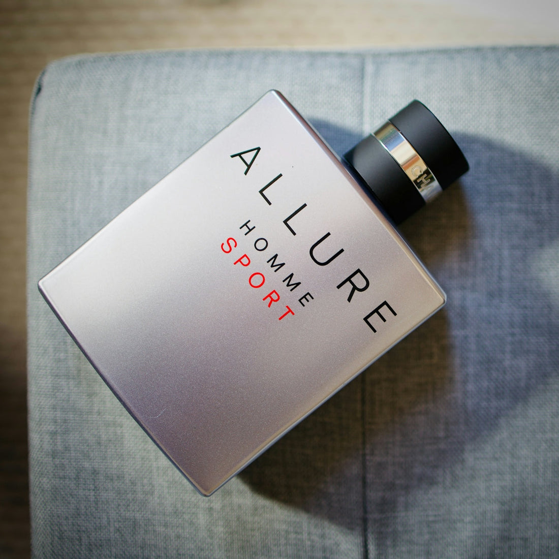 Chanel allure homme sport cologne bottle on gray surface