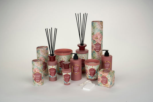 A collection of floral patterned home fragrance products including candles, diffusers, and lotions